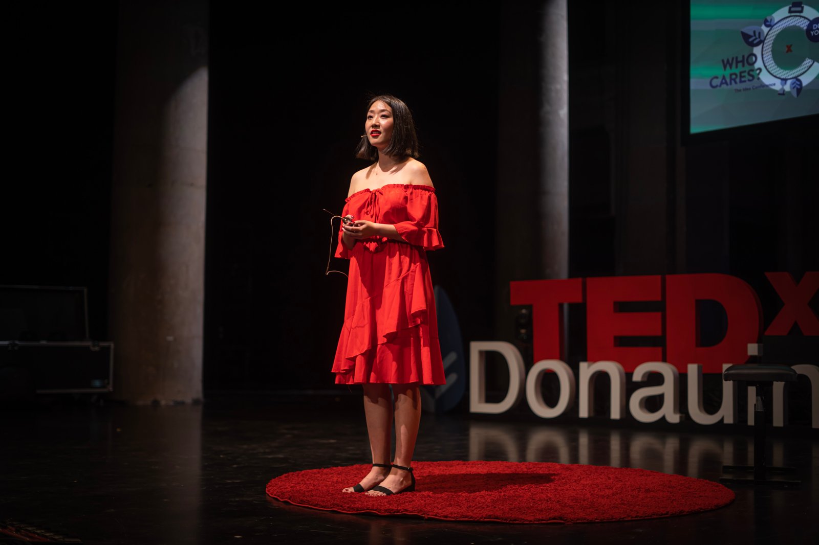 Jiaran Wang speaking at TEDxDonauinsel with the TEDx stage visible